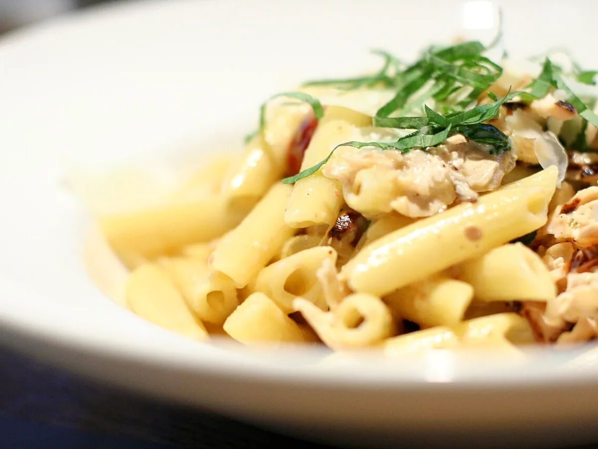 A bowl of creamy pasta tossed with herbs